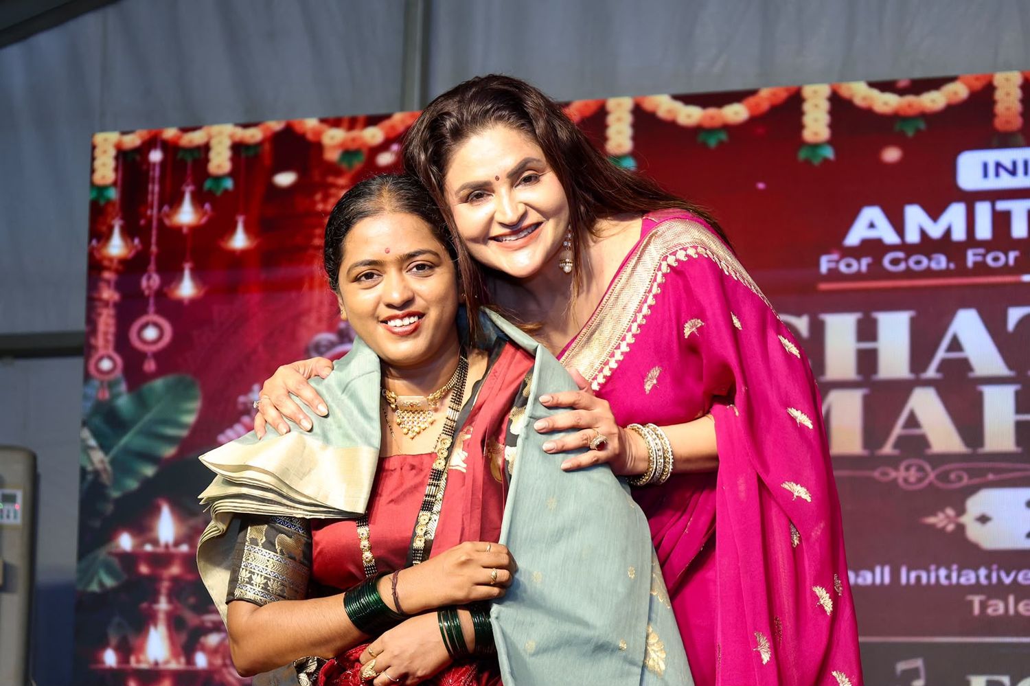 Two women embracing at a community celebration