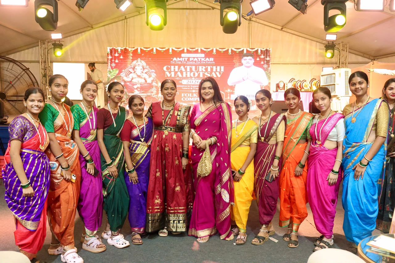 Young women in colourful nauvari saris gathered together at a festival